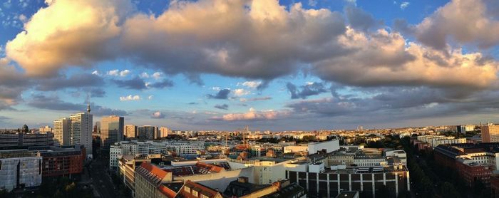 View of cityscape against cloudy sky