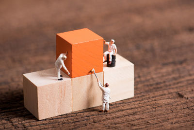 Close-up of figurines and wooden blocks on table