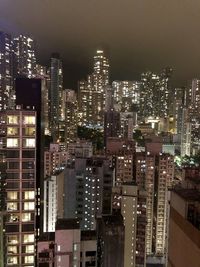 Illuminated cityscape against sky at night