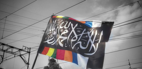 Low angle view of flags against sky