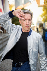 Portrait of man standing on street