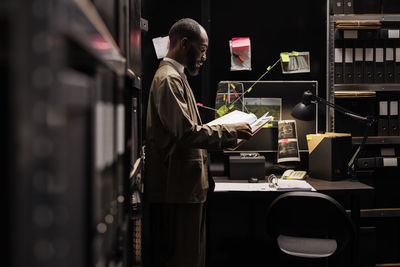 Side view of man working at airport