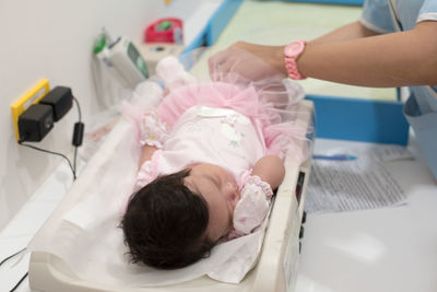 Close-up of baby lying on scales