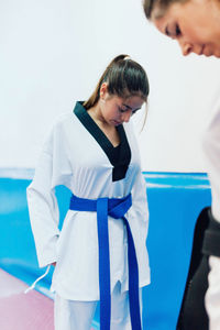 Young woman standing with instructor