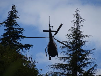 Low angle view of silhouette cross against sky