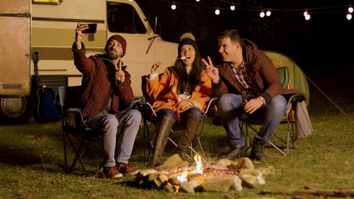 Portrait of friends sitting at park