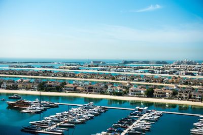 High angle view of harbor by city against sky