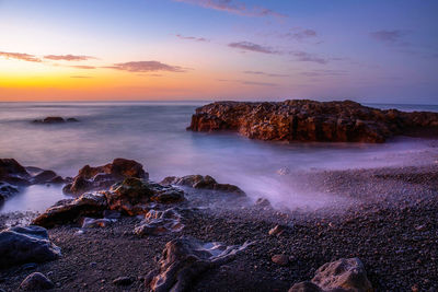 Scenic view of sea against sky during sunset