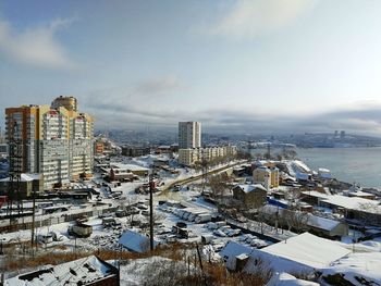 High angle view of snow covered buildings against sky