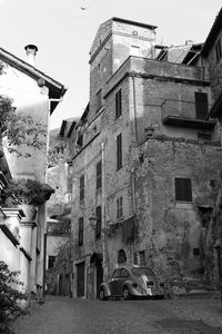 Street amidst buildings in city against sky