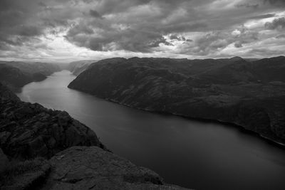 Scenic view of sea and mountains against sky