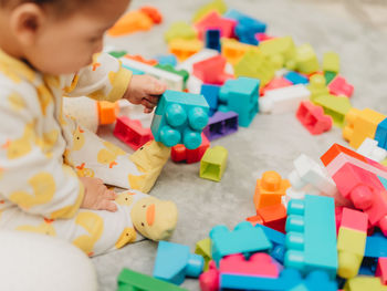 Cute boy playing with toy at home