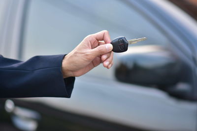 Cropped hand of person holding car key