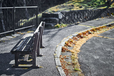 Bench on road in sunny day