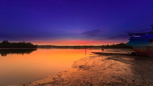 Scenic view of lake against sky at sunset