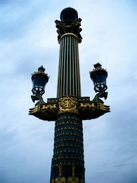 Low angle view of cross against sky