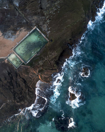 High angle view of sea by rock formation