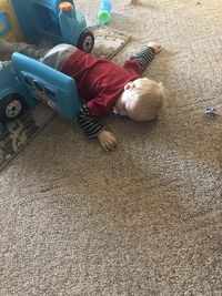 High angle view of cute boy lying on floor