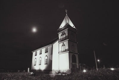 Low angle view of illuminated building against sky at night