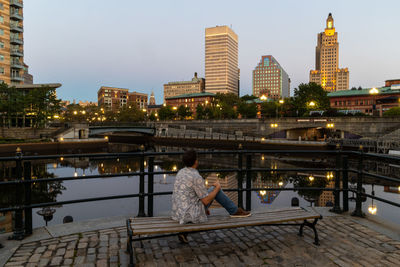 Lone man sitting on a bench in downtown providence