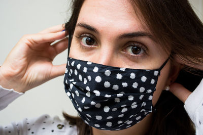 Close-up portrait of young woman covering face