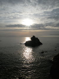 View of calm sea against sky during sunset