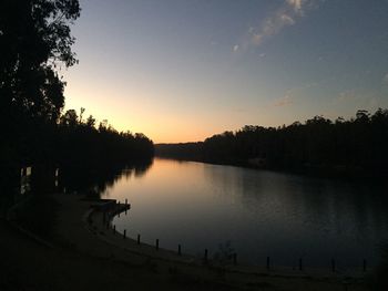 Scenic view of calm lake at sunset