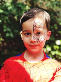 Close-up portrait of boy with face paint