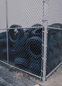 Heap of tires seen through chainlink fence