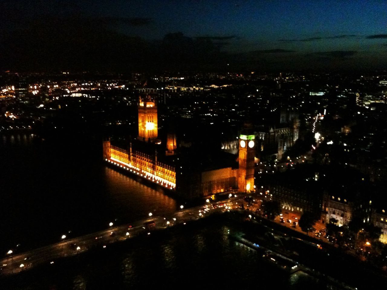 HIGH ANGLE VIEW OF ILLUMINATED CITY AT NIGHT