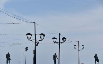 Low angle view of street lights against sky