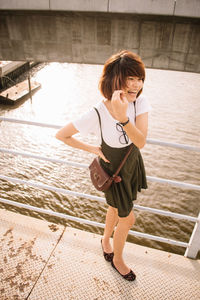 Full length of woman standing at sea shore