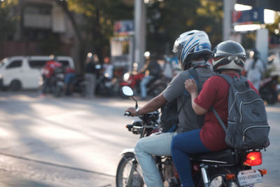 People riding motorcycle on street