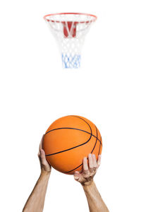 Close-up of hand holding ball against white background