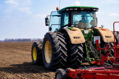 Tractor on field against sky