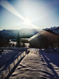 Scenic view of snow covered mountains against sky on sunny day