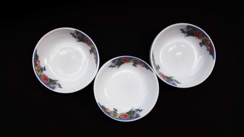 High angle view of empty glasses on table against black background