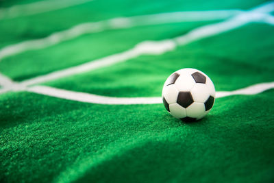 Close-up of figurine soccer ball and playing field