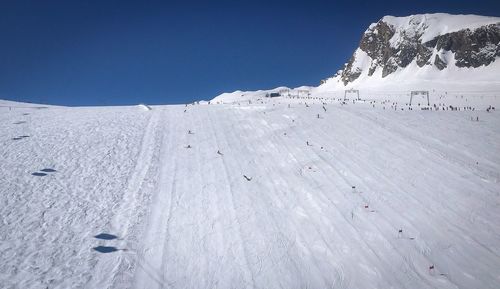 Scenic view of snowcapped mountains against clear sky