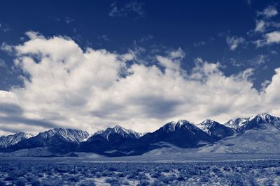 Scenic view of snow covered mountains against sky