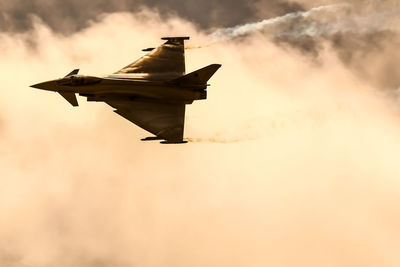 Low angle view of airplane flying against sky