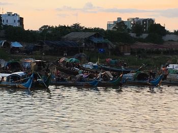 Boats moored on shore against sky