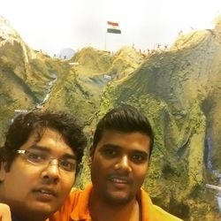 Portrait of smiling young man with mountains in background