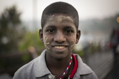 Close-up portrait of smiling boy with face paint