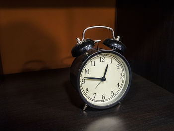 Close-up of clock on table at home