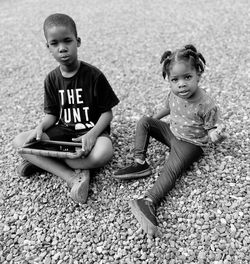 My two grandkids sitting with a tablet 