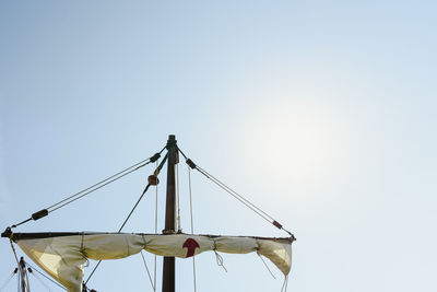 Low angle view of crane against clear sky