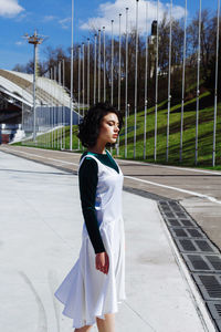 Side view of young woman standing outdoors