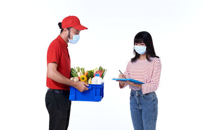 Young couple standing against white background