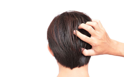 Rear view of a hand against white background